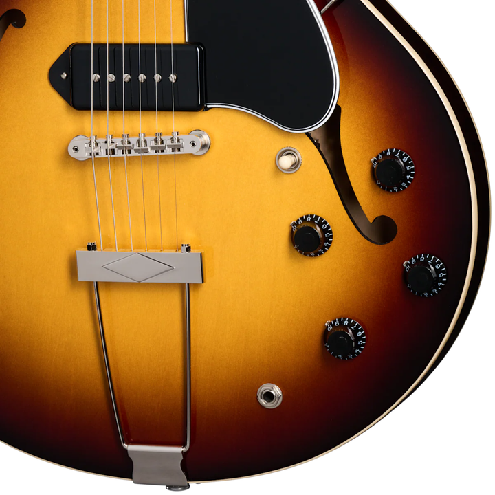 Gibson ES-330. Fully hollow thinline archtop body with no center block. Laminated maple top, back, and sides. Mahogany neck, rosewood fingerboard, 22 frets. P-90 dog-ear pickups. Trapeze tailpiece. Vintage styling. Includes hardshell case.