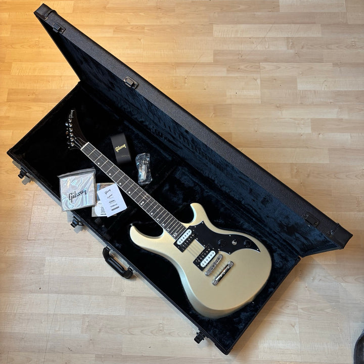 Gibson Victory, Gold Mist Satin. Reintroduced 80s-era cult-favorite solidbody electric. Mahogany body with refined contours. Explorer headstock. 25.5-inch scale SlimTaper mahogany neck, compound radius ebony fretboard, 24 medium jumbo frets. 80s Tribute humbuckers with push/pull master volume and tone controls for coil splitting. Tune-O-Matic bridge, Stop Bar tailpiece. Satin nitrocellulose lacquer finish. Includes hardshell case.