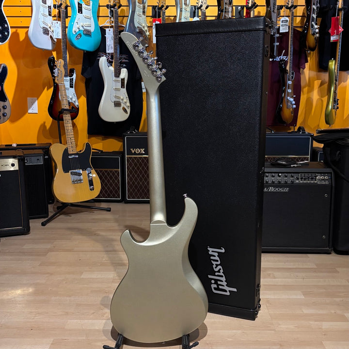Gibson Victory, Gold Mist Satin. Reintroduced 80s-era cult-favorite solidbody electric. Mahogany body with refined contours. Explorer headstock. 25.5-inch scale SlimTaper mahogany neck, compound radius ebony fretboard, 24 medium jumbo frets. 80s Tribute humbuckers with push/pull master volume and tone controls for coil splitting. Tune-O-Matic bridge, Stop Bar tailpiece. Satin nitrocellulose lacquer finish. Includes hardshell case.