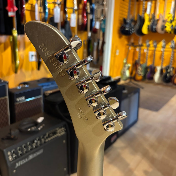 Gibson Victory, Gold Mist Satin. Reintroduced 80s-era cult-favorite solidbody electric. Mahogany body with refined contours. Explorer headstock. 25.5-inch scale SlimTaper mahogany neck, compound radius ebony fretboard, 24 medium jumbo frets. 80s Tribute humbuckers with push/pull master volume and tone controls for coil splitting. Tune-O-Matic bridge, Stop Bar tailpiece. Satin nitrocellulose lacquer finish. Includes hardshell case.