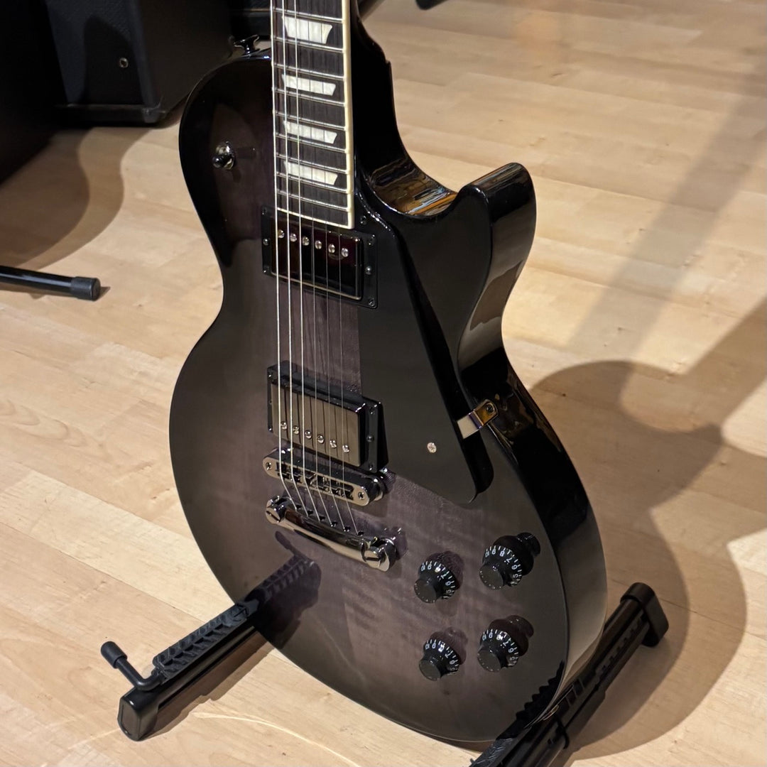 Gibson Les Paul Studio Modern. Ultra Modern weight-relieved mahogany body with maple cap. Modern Contoured Heel for exceptional upper-fret access. Mahogany neck with rounded profile. Compound radius bound ebony fretboard. 490R and 498T pickups with coil tapping, phase switching, and pure bypass. Black nickel hardware. Includes soft shell case.