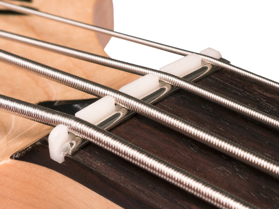 The Zero Glide Replacement Nut System borrows the "zero fret" concept to reduce string contact in the nut by up to 93%, increasing tuning stability, playability, and open string tone. It only takes a few minutes to install with absolutely no permanent alteration to your instrument. For Fender Style "Jazz Bass". Available in Black Delrin.