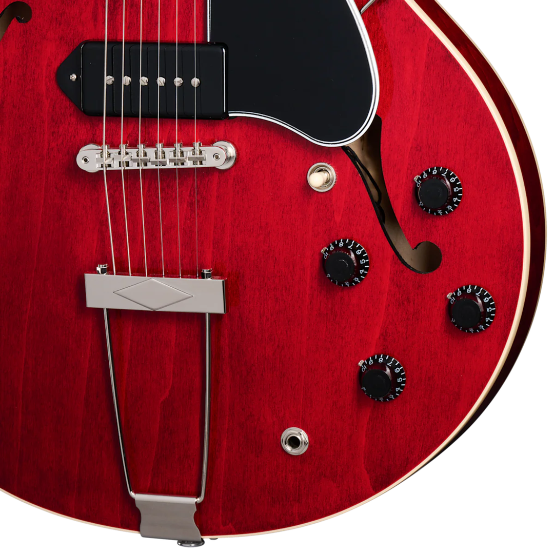 Gibson ES-330. Fully hollow thinline archtop body with no center block. Laminated maple top, back, and sides. Mahogany neck, rosewood fingerboard, 22 frets. P-90 dog-ear pickups. Trapeze tailpiece. Vintage styling. Includes hardshell case.