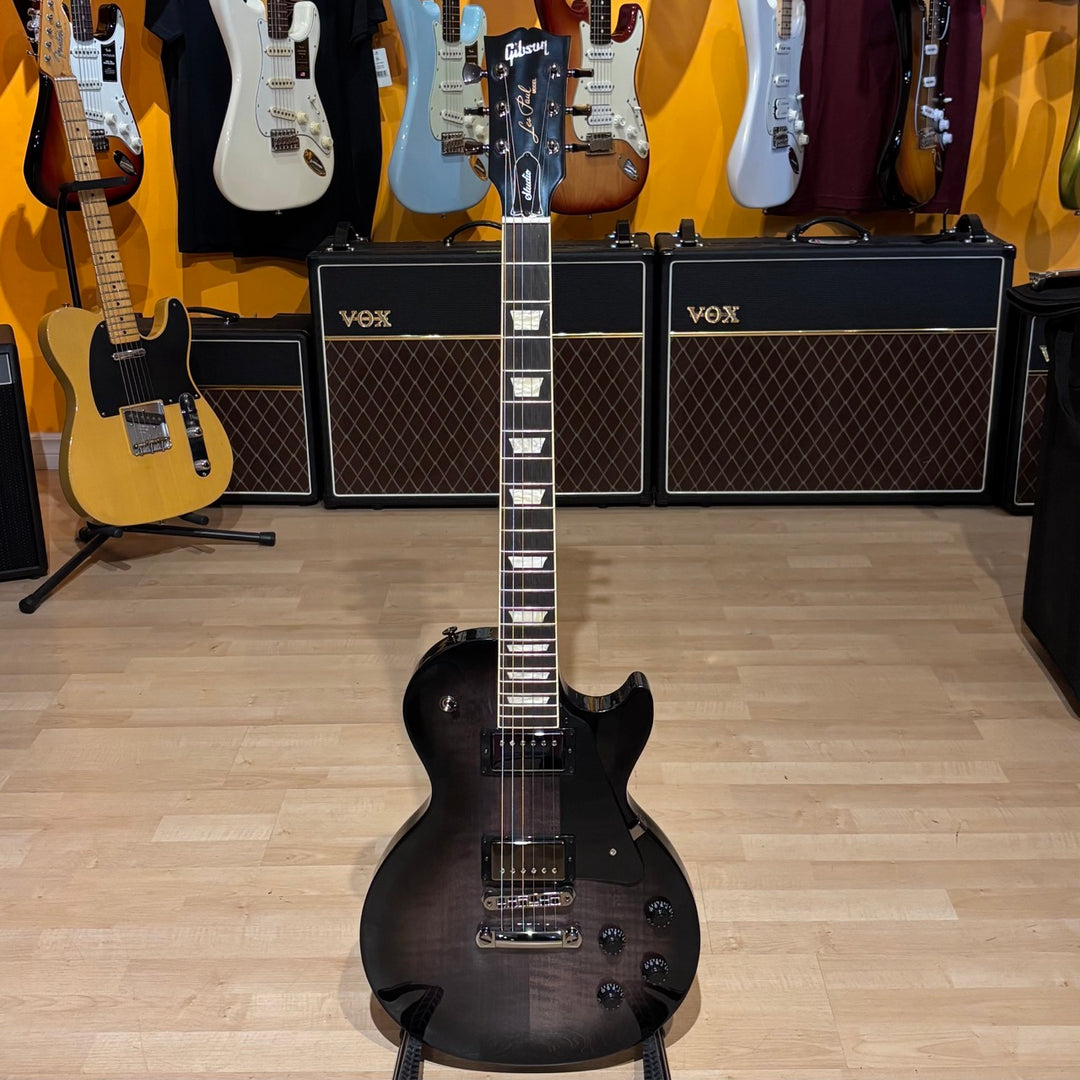 Gibson Les Paul Studio Modern. Ultra Modern weight-relieved mahogany body with maple cap. Modern Contoured Heel for exceptional upper-fret access. Mahogany neck with rounded profile. Compound radius bound ebony fretboard. 490R and 498T pickups with coil tapping, phase switching, and pure bypass. Black nickel hardware. Includes soft shell case.