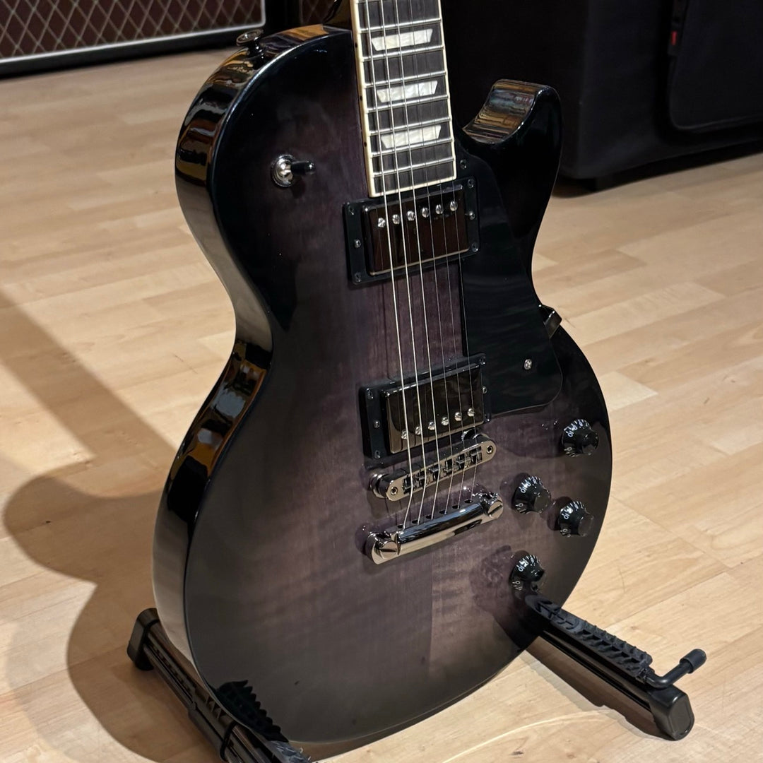 Gibson Les Paul Studio Modern. Ultra Modern weight-relieved mahogany body with maple cap. Modern Contoured Heel for exceptional upper-fret access. Mahogany neck with rounded profile. Compound radius bound ebony fretboard. 490R and 498T pickups with coil tapping, phase switching, and pure bypass. Black nickel hardware. Includes soft shell case.